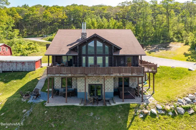 an aerial view of a house with swimming pool garden and patio