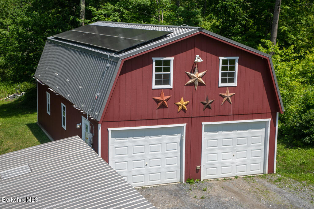 214 Mohawk Trail Florida, MA 01247 - Photo 36 of 40 a front view of a house with a garage