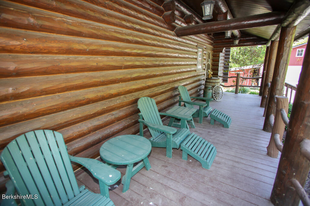 214 Mohawk Trail Florida, MA 01247 - Photo 5 of 40 a view of a porch with furniture and a yard