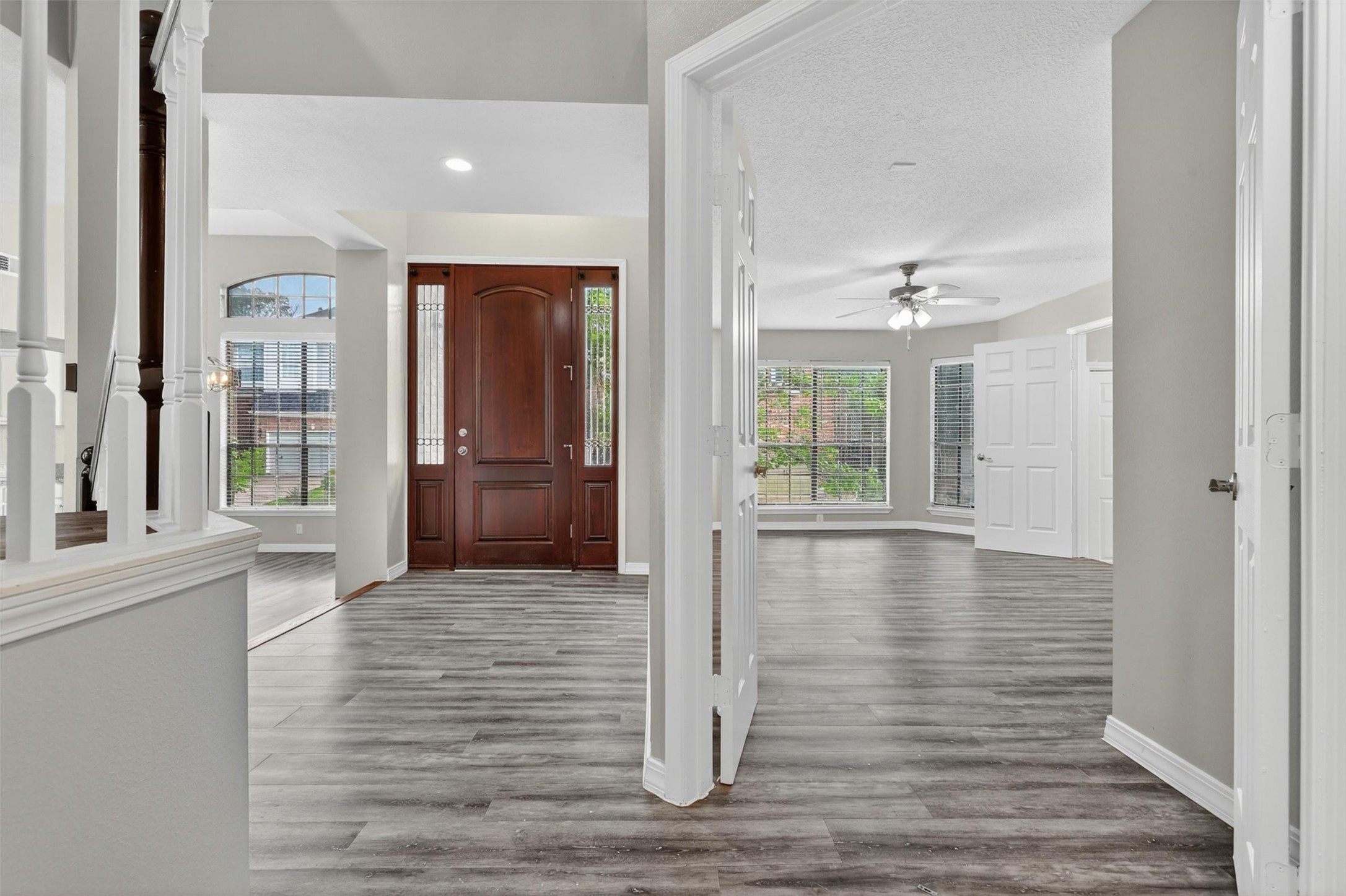 12929 Kingsbridge Lane Houston, TX 77077 - Photo 41 of 42 Step through the elegant entryway into a home filled with natural light, soaring ceilings, and a spacious open layout buyers are searching for. The impressive front door creates a warm and luxurious first impression, while the expansive windows and modern flooring add style and sophistication throughout. This versatile floor plan offers ideal spaces for entertaining, working from home, or relaxing in comfort.