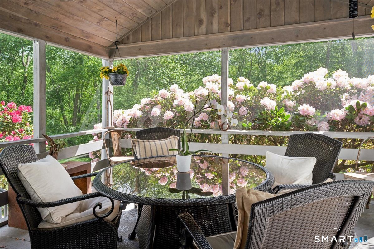 94 Vista Road Wilton, CT 06897 - Photo 11 of 38 a view of a chairs and table in the patio