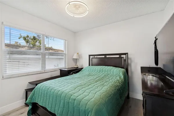 a bathroom with a granite countertop sink toilet and mirror