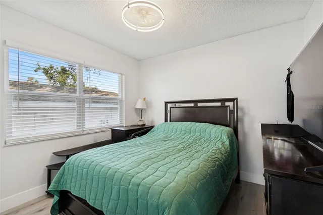 a bathroom with a granite countertop sink toilet and mirror