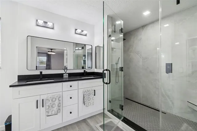 a bathroom with a granite countertop sink a toilet and mirror