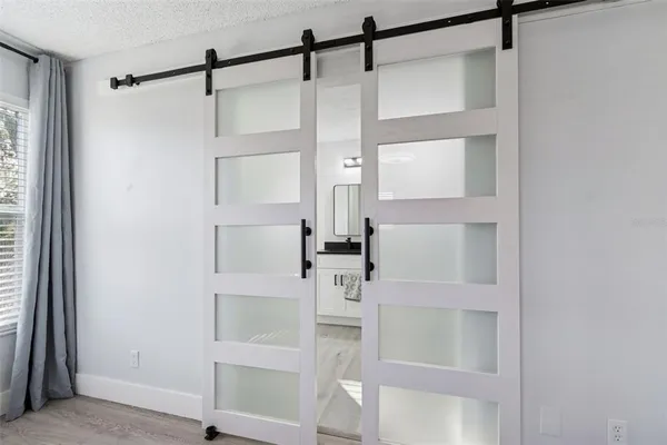 a bathroom with a granite countertop sink a toilet and a shower