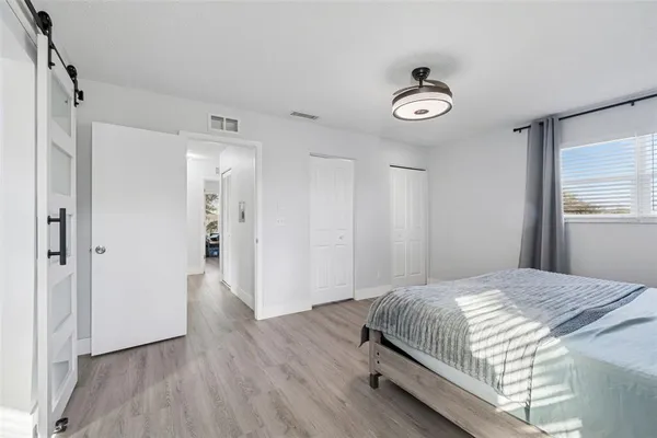 a bedroom with a bed and a chandelier