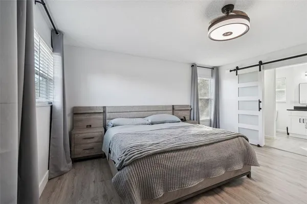 a living room with a window and a ceiling fan