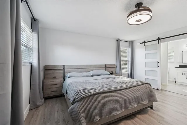 a living room with a window and a ceiling fan