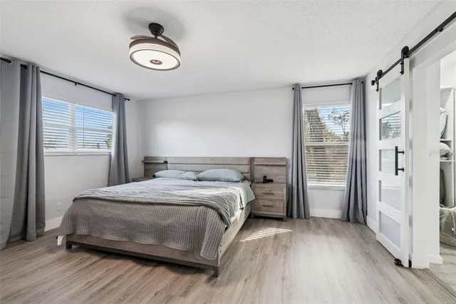 a living room with wooden floor and window