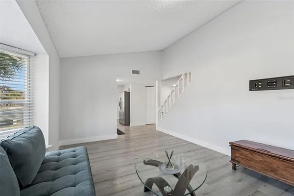 a kitchen with a refrigerator and a stove top oven