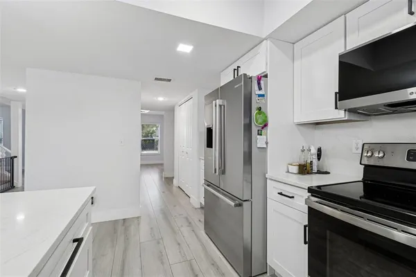 a kitchen with a sink cabinets and window