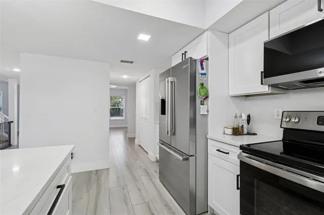 a kitchen with a sink cabinets and window