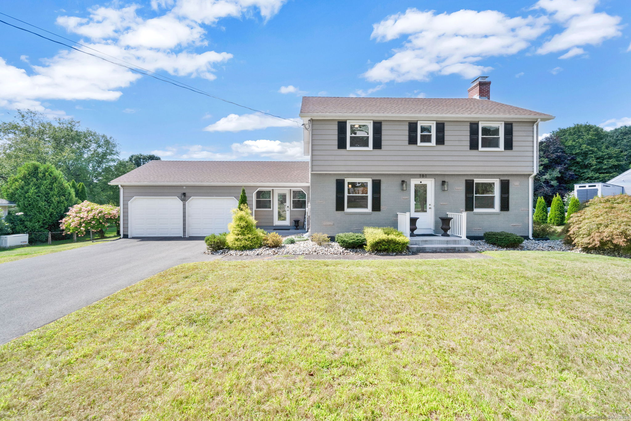 a front view of a house with yard and patio