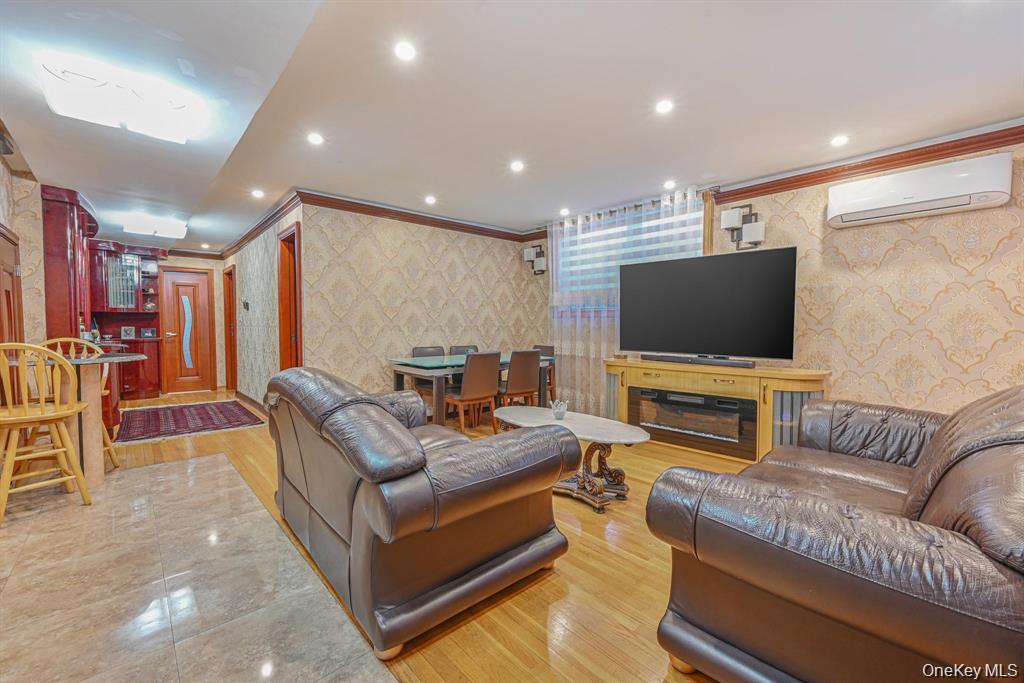 102-01 62nd Road Queens, NY 11375 - Photo 12 of 16 a living room with furniture and a flat screen tv