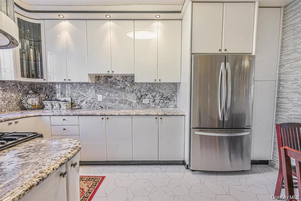 102-01 62nd Road Queens, NY 11375 - Photo 7 of 16 a kitchen with stainless steel appliances granite countertop a refrigerator and a sink