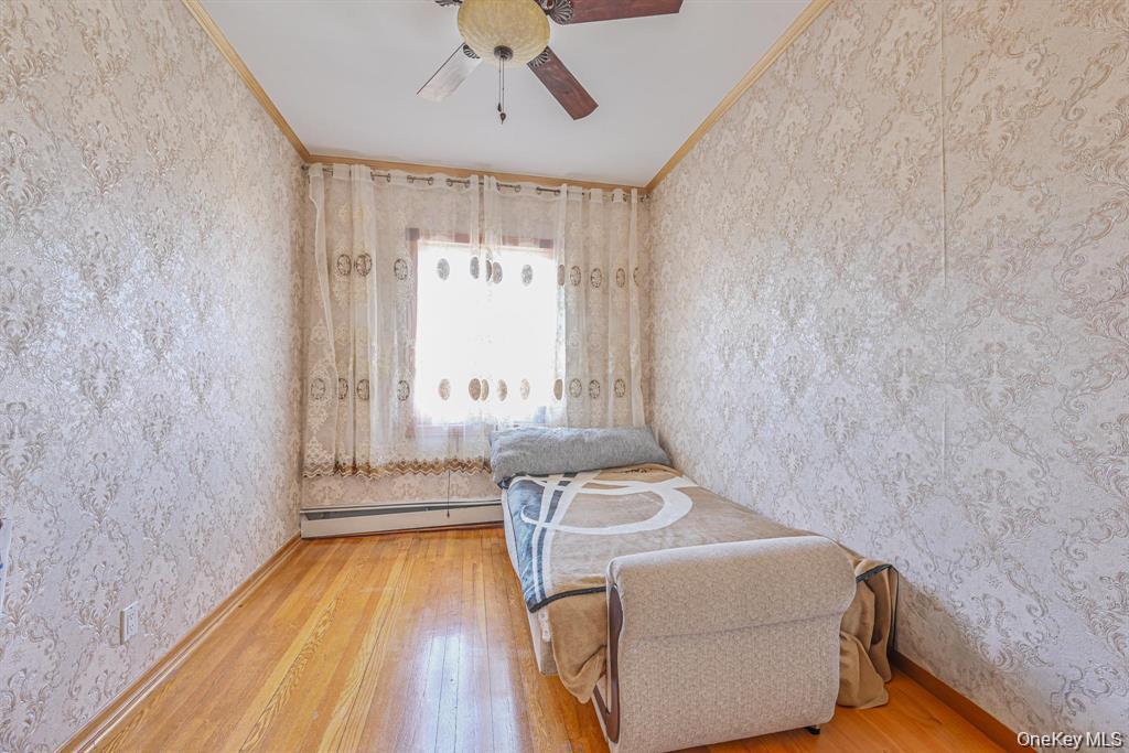 102-01 62nd Road Queens, NY 11375 - Photo 10 of 16 a bedroom with a bed and a window