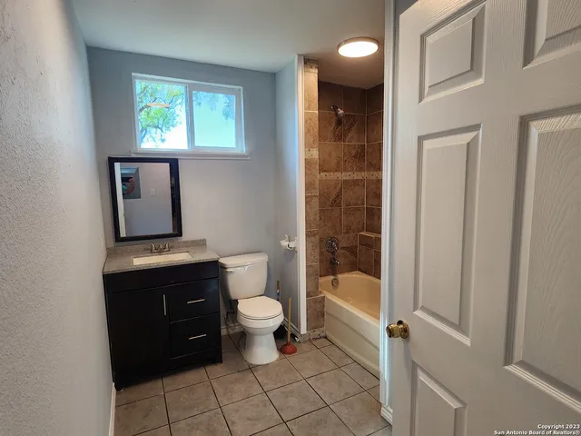 a bathroom with a toilet a sink and bathtub