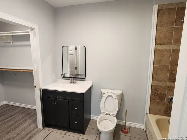 a bathroom with a toilet a sink and mirror