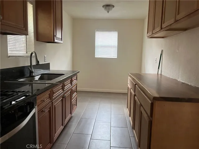 a kitchen with a sink and a stove top oven