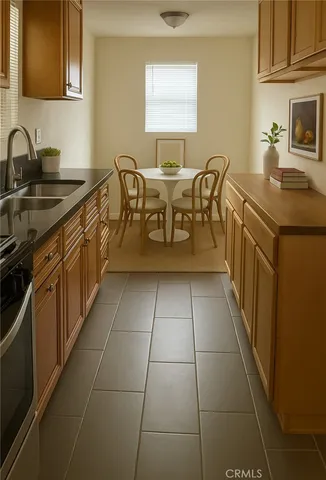 a kitchen with a sink a stove and cabinets