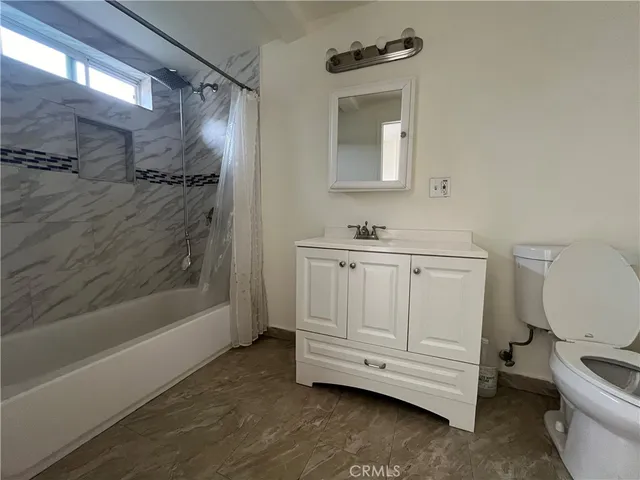 a bathroom with a toilet a sink and bathtub