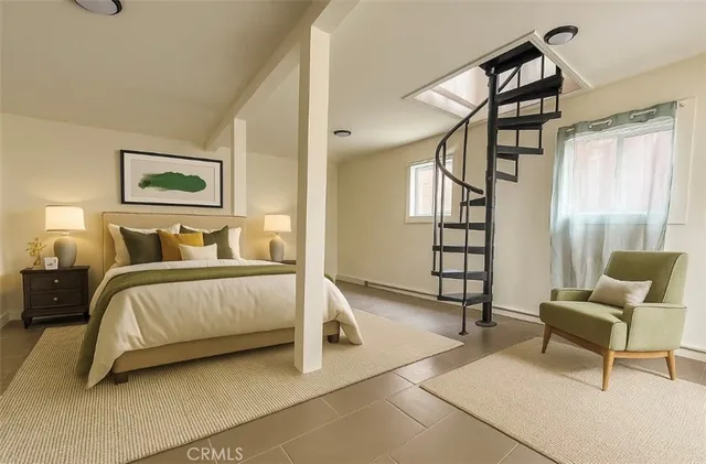 a bedroom with a bed and a window