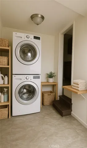 a view of a storage and utility room with washer and dryer