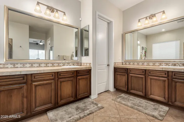 a view of walk in closet with clothes