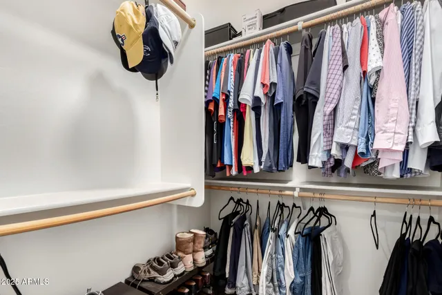 a bedroom with bed and a mirror