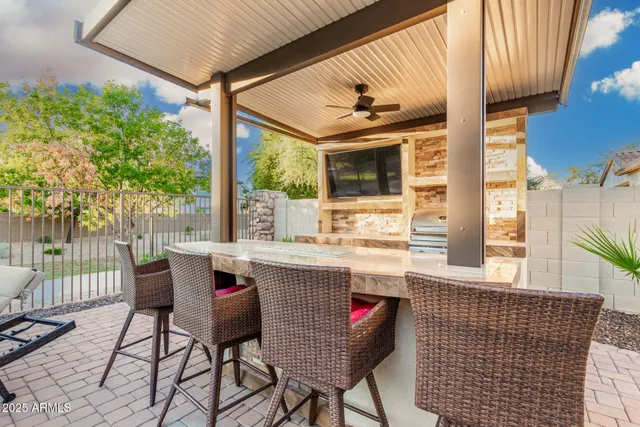 an aerial view of ocean and residential houses with outdoor space