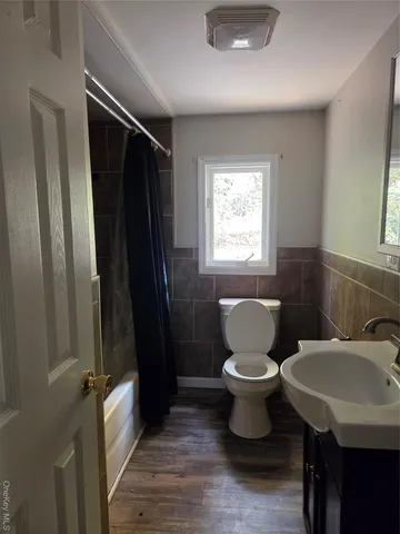 a bathroom with a toilet sink and a mirror