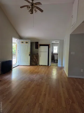 a view of a livingroom with a ceiling fan and window