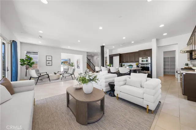 a living room with furniture and a view of kitchen