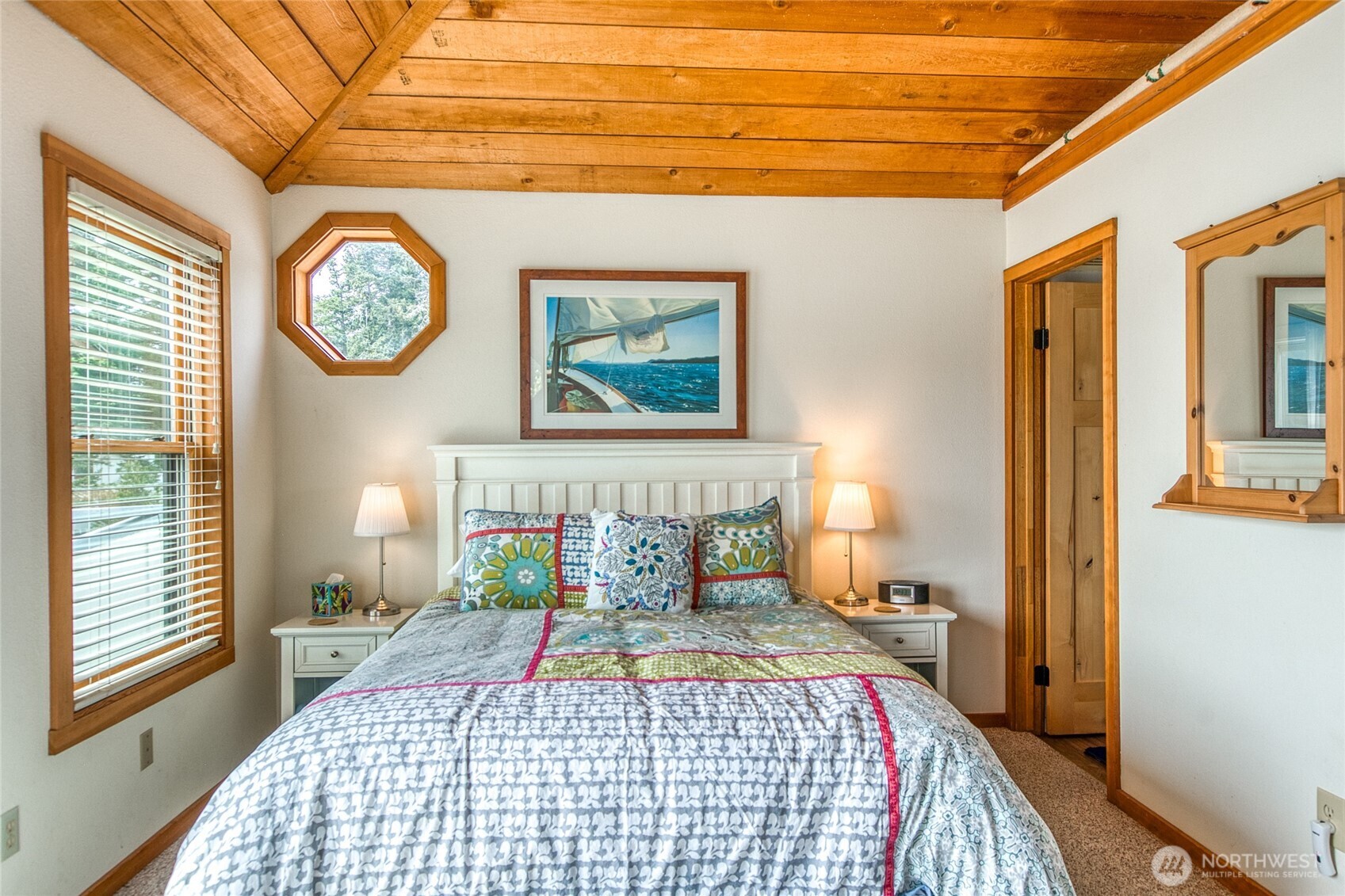 942 Deer Harbor Road Orcas Island, WA 98245 - Photo 26 of 40 a bedroom with a bed a mirror and a window