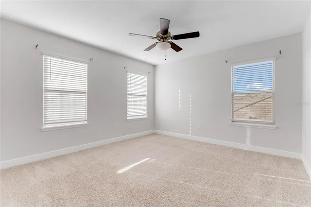 a view of a livingroom with a ceiling fan and window