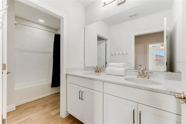 a bathroom with a double vanity sink and mirror