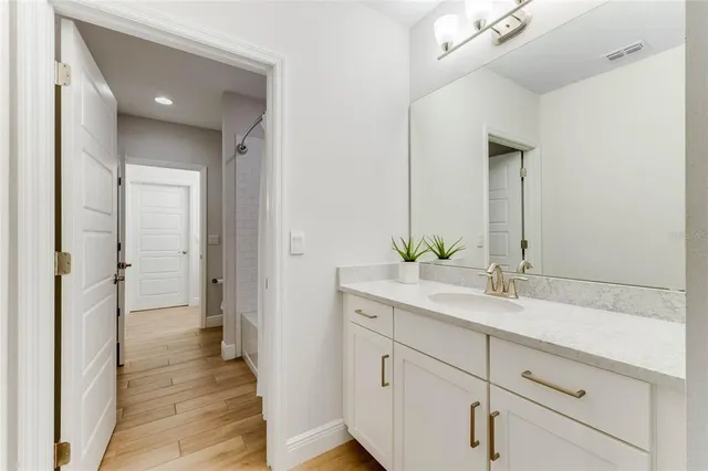 a bathroom with a double vanity sink and mirror
