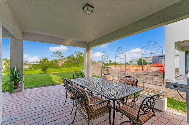 a view of a patio with a table chairs and a backyard