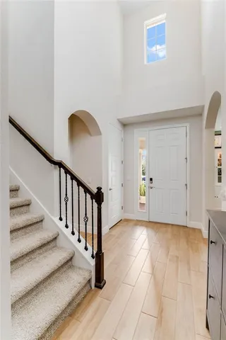 a view of an entryway with wooden floor