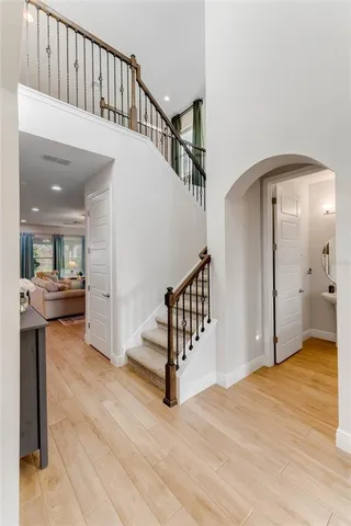 a view of entryway and hall with wooden floor