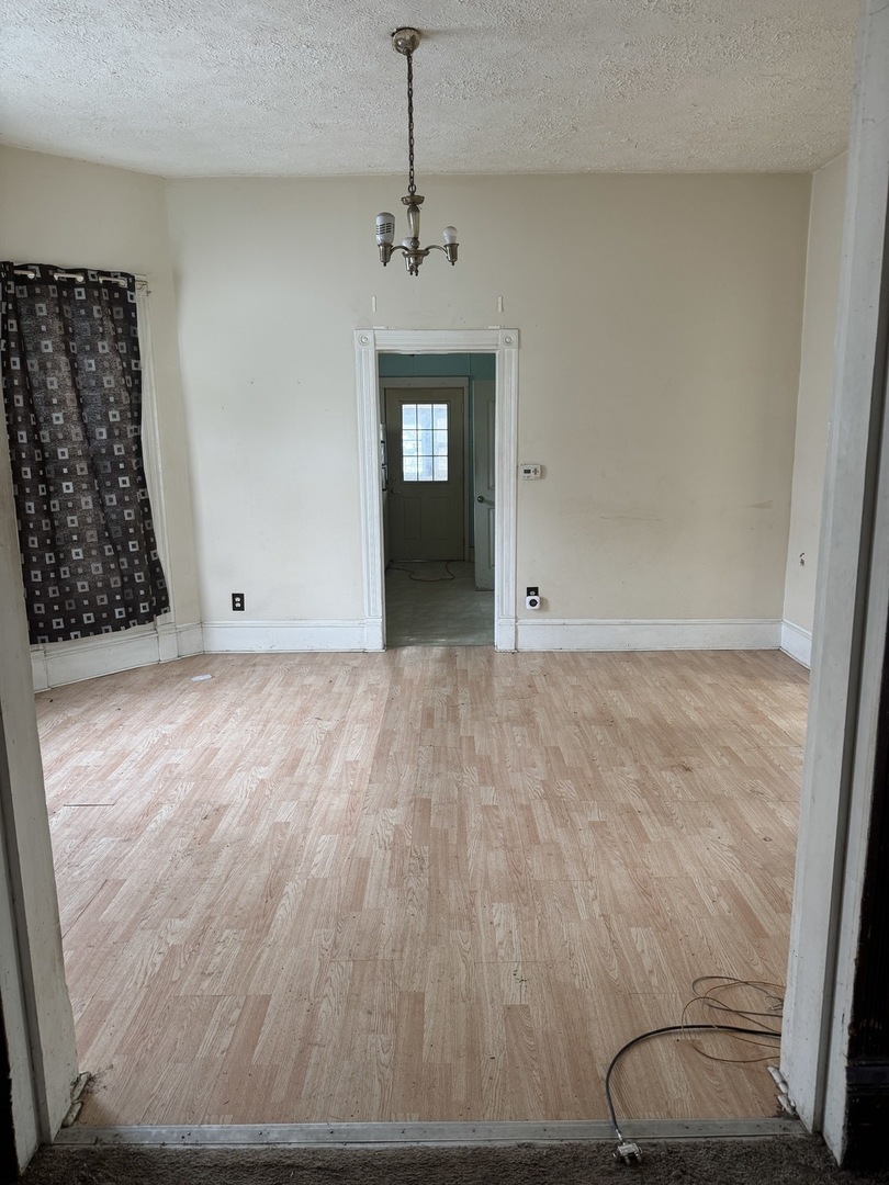 916 West Front Street Bloomington, IL 61701 - Photo 6 of 15 wooden floor in an empty room with a window