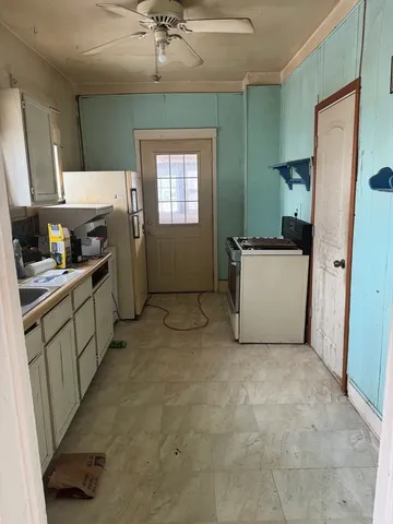 a kitchen with stainless steel appliances a refrigerator sink and cabinets