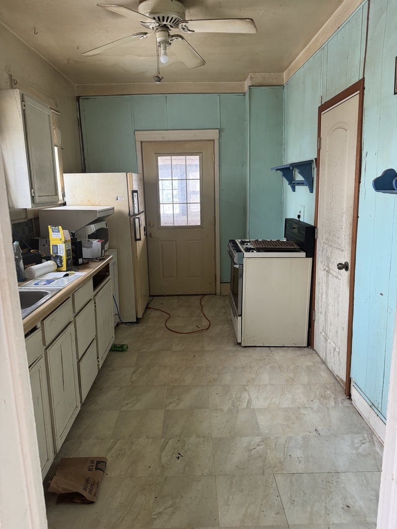 916 West Front Street Bloomington, IL 61701 - Photo 9 of 15 a kitchen with stainless steel appliances a refrigerator sink and cabinets