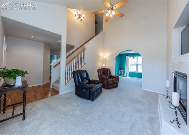 8587 Saddleman Road Peyton, CO 80831 - Photo 2 of 31 Living Room with Fireplace