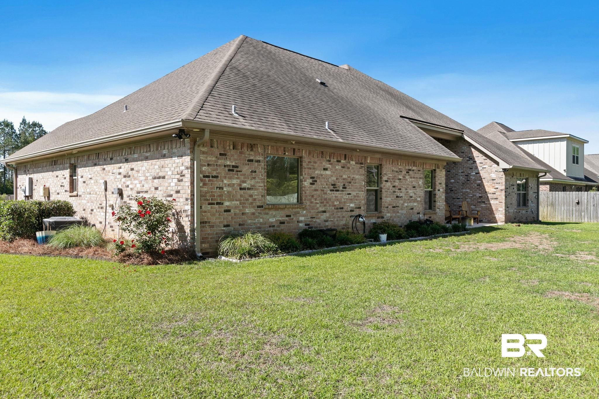 31911 Bobwhite Road Daphne, AL 36527 - Photo 53 of 85 View of home's exterior featuring brick siding, roof with shingles, and a lawn