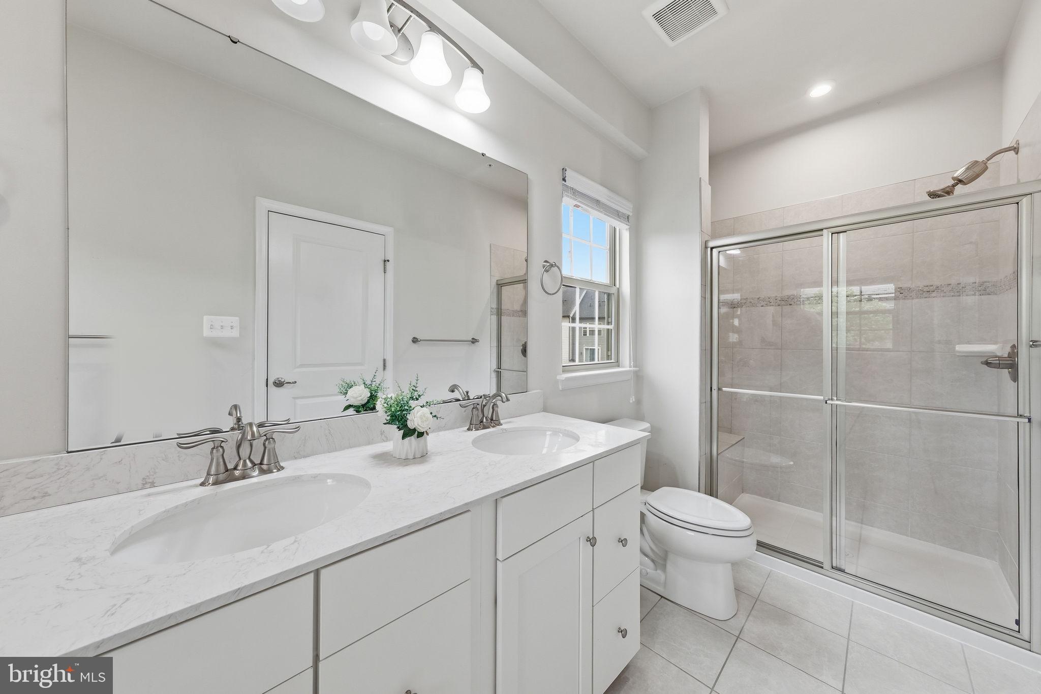 3012 Bretons Ridge Way Hanover, MD 21076 - Photo 22 of 37 a bathroom with a sink toilet and shower