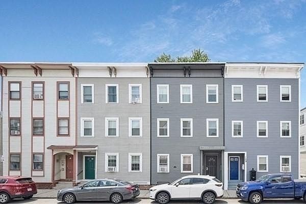a front view of building with cars parked