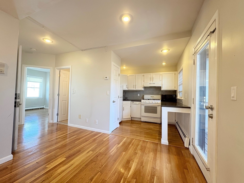 131 West Seventh Street, Unit 2 Boston, MA 02127 - Photo 2 of 11 a view of kitchen with wooden floor and electronic appliances