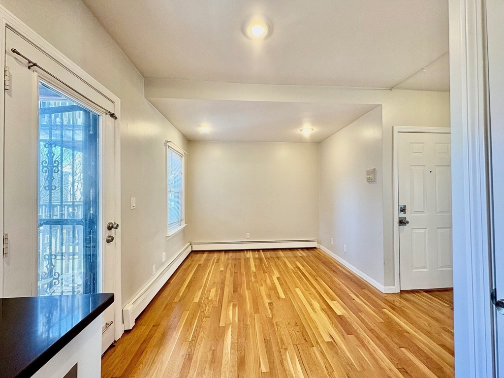 131 West Seventh Street, Unit 2 Boston, MA 02127 - Photo 4 of 11 a view of a room with wooden floor and brick walls