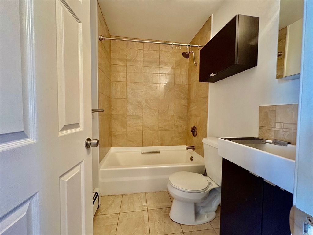 131 West Seventh Street, Unit 2 Boston, MA 02127 - Photo 8 of 11 a bathroom with a toilet a sink and bathtub